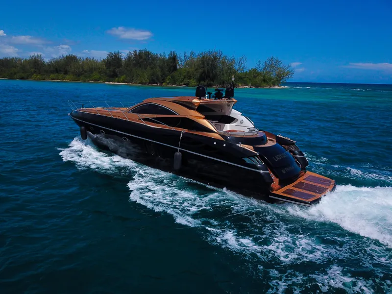 Slide: The Image of 2005 Sunseeker Predator 68 yacht cruising on blue ocean near lush island. - 44