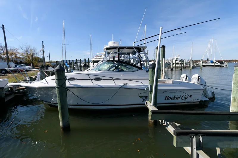The Image of 2005 Stamas 320 Express boat docked, featuring Suzuki 350 repower, in a marina setting. - 0