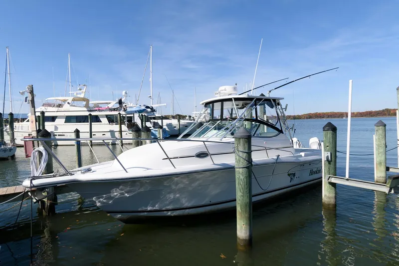 Slide: The Image of 2005 Stamas 320 Express boat docked, featuring Suzuki 350 repower, in a marina setting. - 1