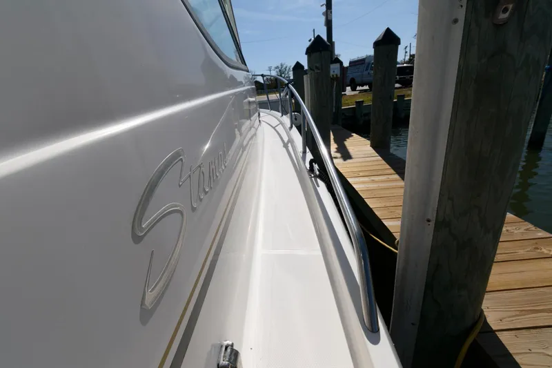 Slide: The Image of 2005 Stamas 320 Express boat docked, featuring Suzuki 350 repower. - 11