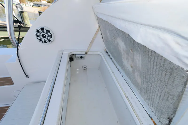 Slide: The Image of Open storage compartment on 2005 Stamas 320 Express boat, featuring Suzuki 350 repower. - 14