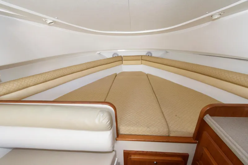 Slide: The Image of Interior cabin of 2005 Stamas 320 Express boat with beige cushions and wood accents. - 18