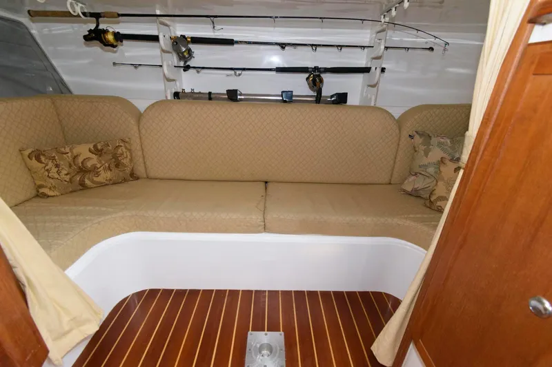 Slide: The Image of Interior of 2005 Stamas 320 Express boat with beige seating and fishing rods. - 19