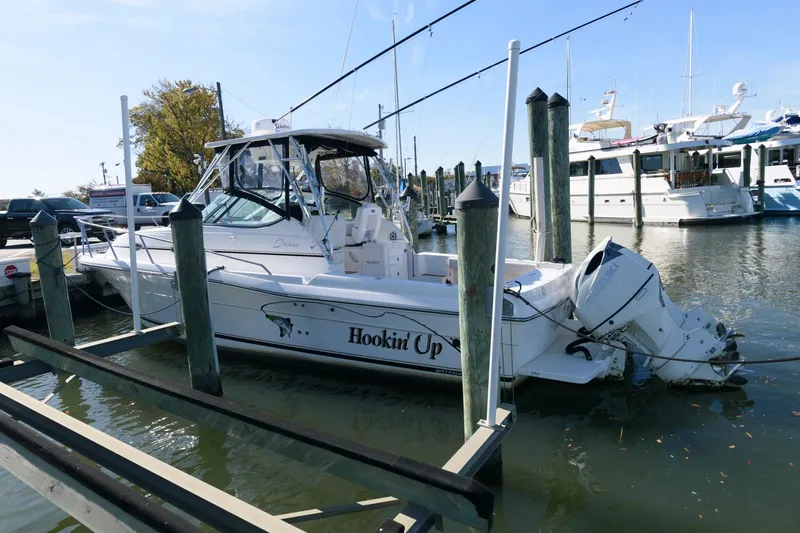 Slide: The Image of 2005 Stamas 320 Express boat with Suzuki 350 engine docked at marina. - 2