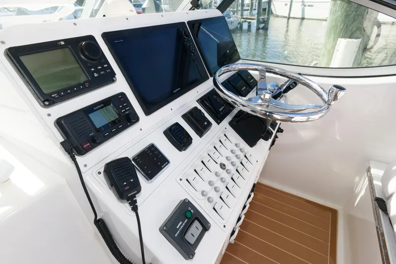 Slide: The Image of Control panel of 2005 Stamas 320 Express boat with Suzuki 350 repower, featuring modern navigation equipment. - 6