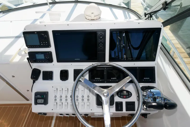 Slide: The Image of Control panel of 2005 Stamas 320 Express boat with Suzuki 350 repower, featuring modern navigation equipment. - 7