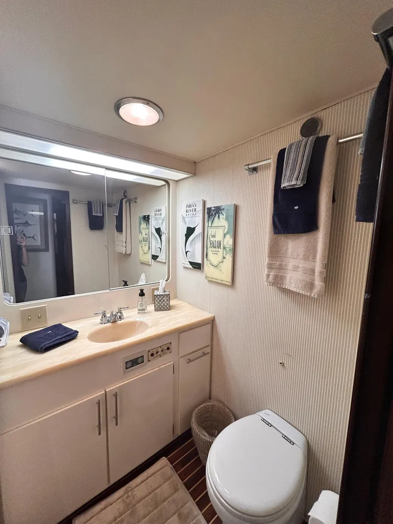Slide: The Image of Bathroom interior of 1989 Hatteras 67 Cockpit Motor Yacht, featuring sink and toilet. - 16