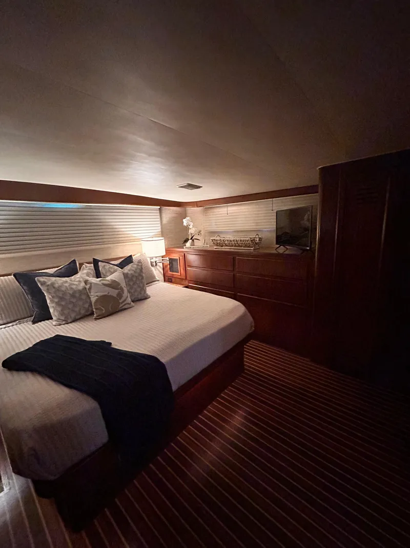 Slide: The Image of Luxurious bedroom in 1989 Hatteras 67 Cockpit Motor Yacht with elegant wood finishes. - 21