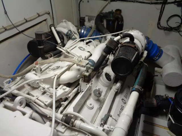 Slide: The Image of Engine room of 1989 Hatteras 67 Cockpit Motor Yacht, showcasing dual engines and components. - 36