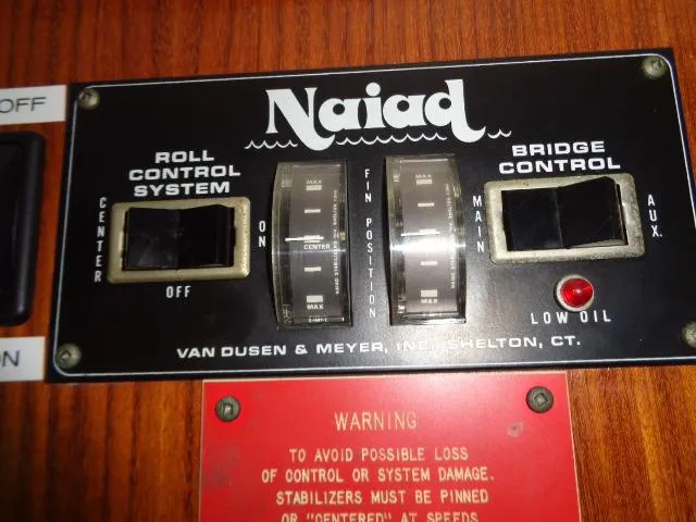 Slide: The Image of Naiad control panel on 1989 Hatteras 67 Cockpit Motor Yacht, featuring roll and bridge control systems. - 4
