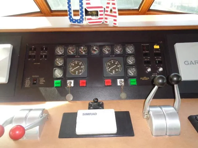 Slide: The Image of Control panel of 1989 Hatteras 67 Cockpit Motor Yacht with navigation instruments and USA decoration. - 6