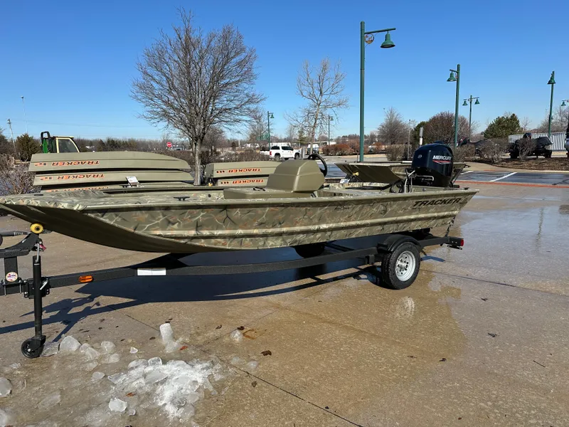 The Image of 2025 Tracker Grizzly 1648 SC boat on trailer, parked outdoors on a sunny day. - 0