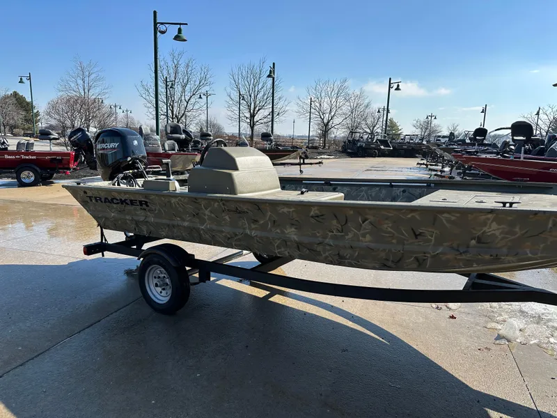Slide: The Image of 2025 Tracker Grizzly 1648 SC boat on trailer, outdoor display. - 2