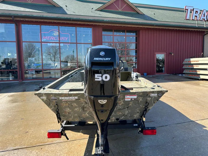 Slide: The Image of 2025 Tracker Grizzly 1648 SC boat with Mercury 50 engine, parked outside dealership. - 4