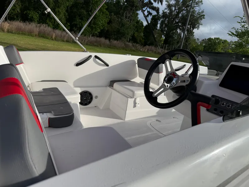 Slide: The Image of 2025 Tahoe T18 boat interior with steering wheel, seating, and control panel. - 2