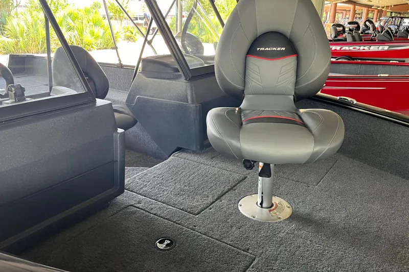 Slide: The Image of 2025 Tracker Pro Guide V-175 Combo boat interior with gray seating and carpeted flooring. - 6