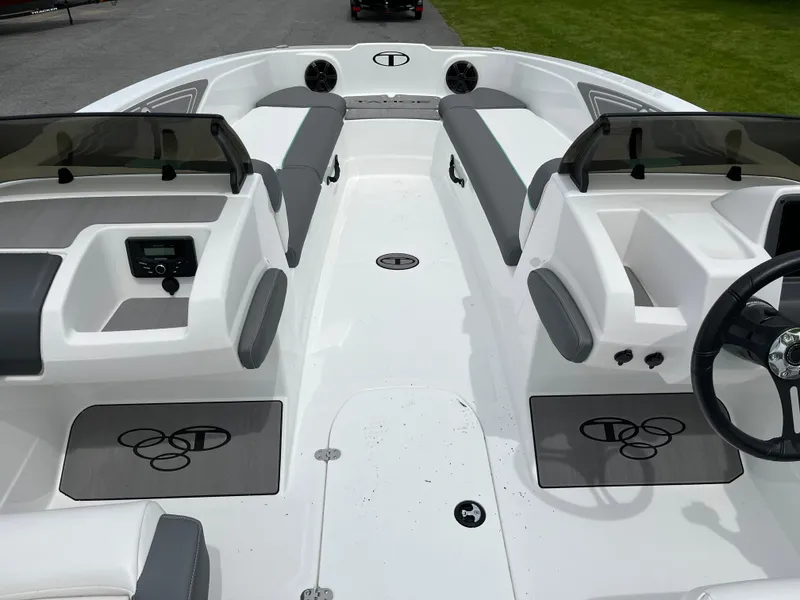 Slide: The Image of 2025 Tahoe T21 boat interior with sleek white and gray seating, modern dashboard, and spacious layout. - 5