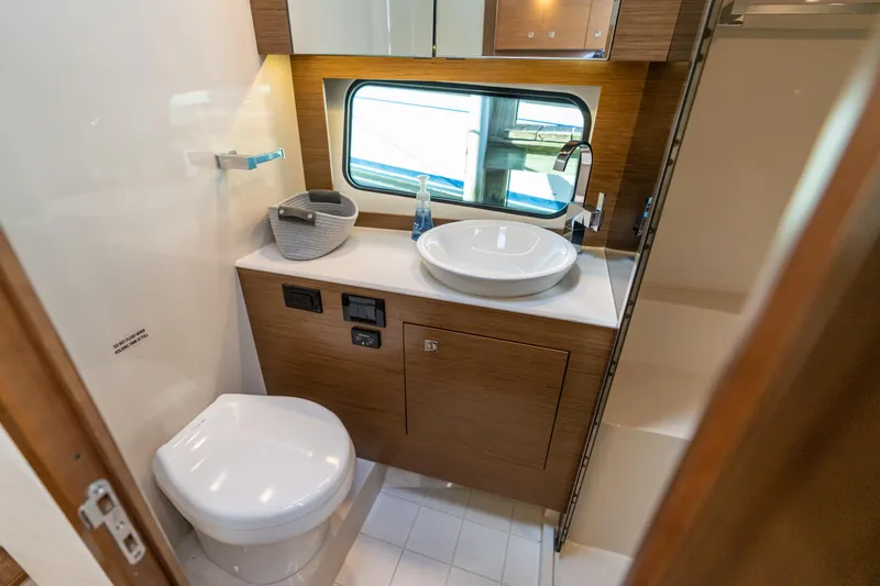 Slide: The Image of Luxurious bathroom in 2017 Cruisers Yachts 390 Express Coupe with modern fixtures and window view. - 40