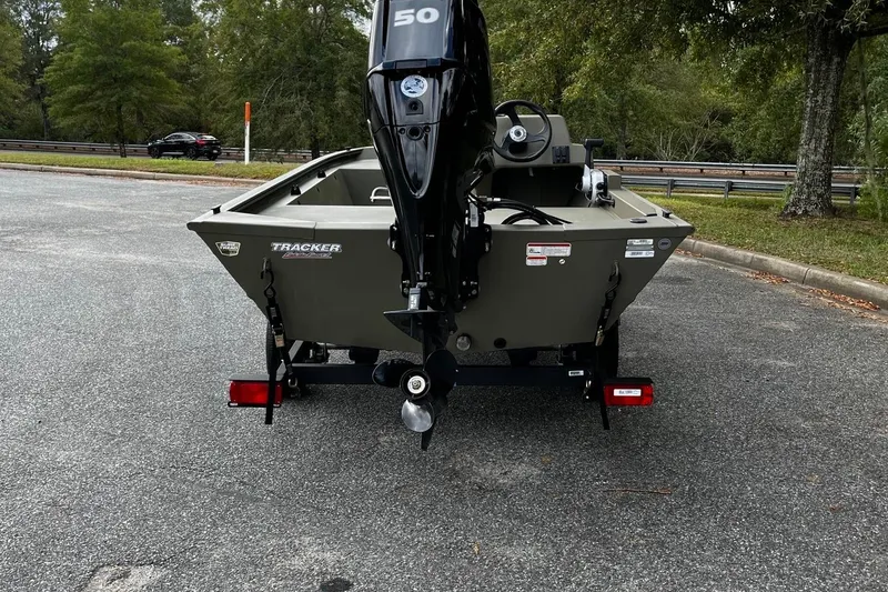 Slide: The Image of 2025 Tracker Grizzly 1648 SC boat with outboard motor in parking lot. - 4