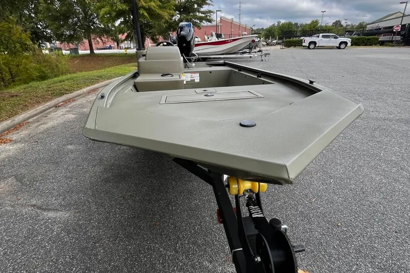 Slide: The Image of 2025 Tracker Grizzly 1648 SC boat on trailer, parked outdoors. - 6