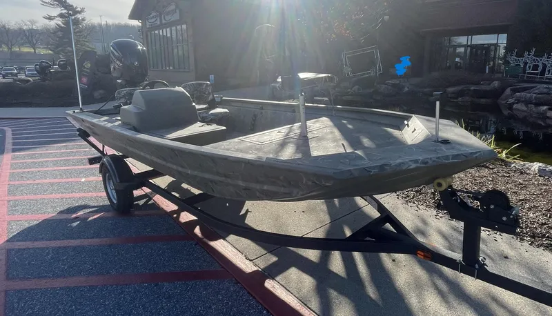 Slide: The Image of 2025 Tracker Grizzly 1754 SC boat on trailer in outdoor setting. - 2