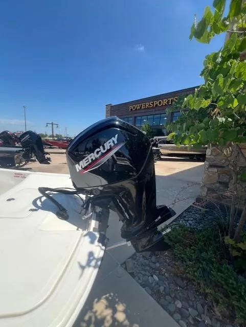 Slide: The Image of 2025 Mako Pro Skiff 17 CC with Mercury outboard motor at Powersports dealership. - 6