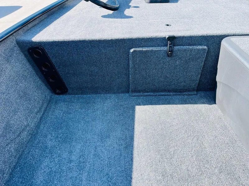 Slide: The Image of 2025 Tracker Bass Tracker Classic XL interior with gray carpet and storage compartment. - 13