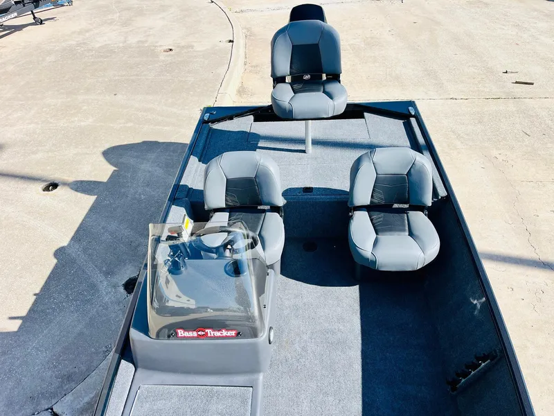 Slide: The Image of 2025 Tracker Bass Tracker Classic XL boat with three seats and console on deck. - 17
