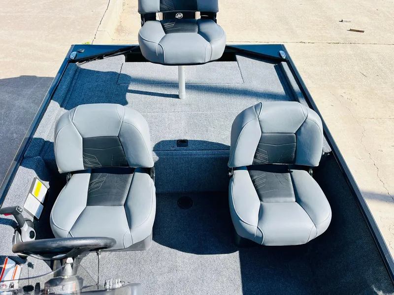 Slide: The Image of 2025 Tracker Bass Tracker Classic XL boat with three gray seats on deck. - 18