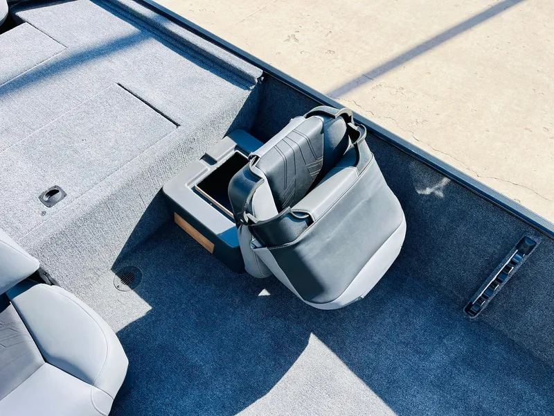 Slide: The Image of 2025 Tracker Bass Tracker Classic XL boat interior with gray seating and storage compartment. - 19