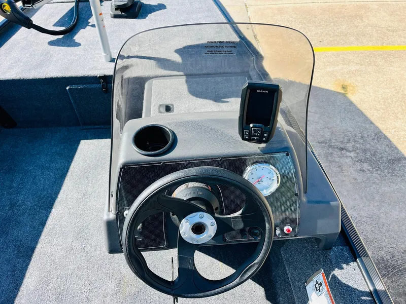 Slide: The Image of 2025 Tracker Bass Tracker Classic XL dashboard with steering wheel and navigation system. - 24