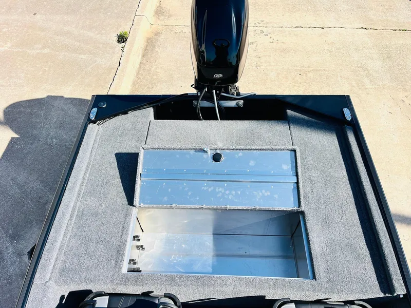 Slide: The Image of 2025 Tracker Bass Tracker Classic XL boat with open storage compartment and motor. - 28