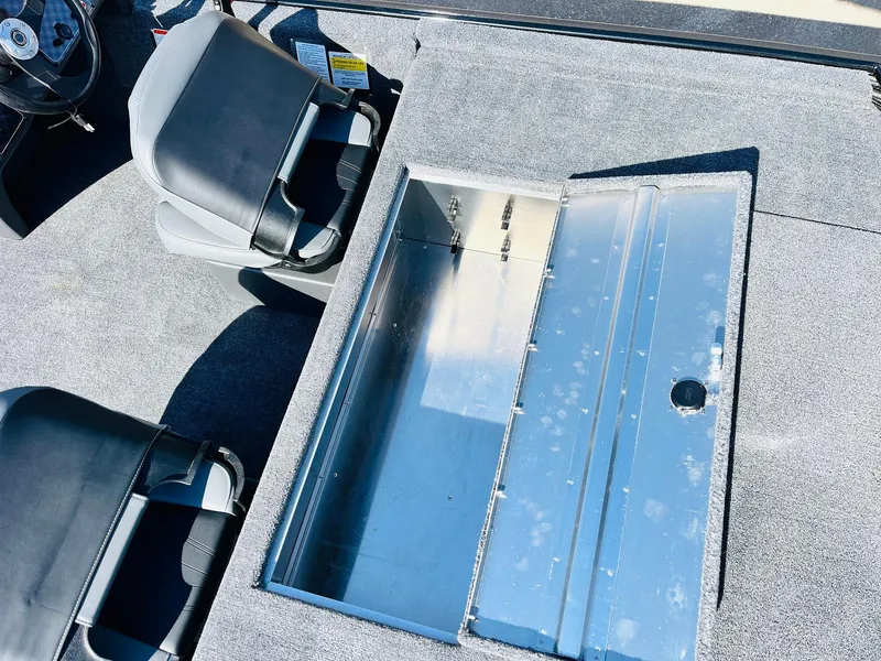 Slide: The Image of 2025 Tracker Bass Tracker Classic XL boat interior with open storage compartment. - 31
