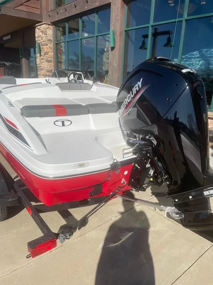 Slide: The Image of 2025 Tahoe T16 boat with Mercury outboard motor, parked on a trailer. - 2