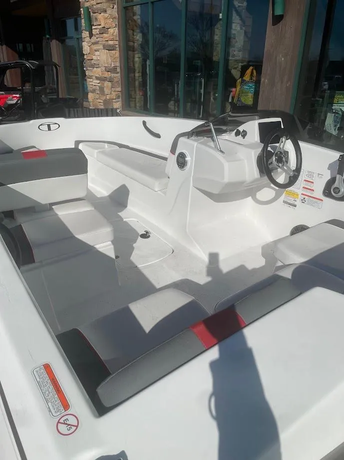 Slide: The Image of 2025 Tahoe T16 boat interior with modern steering and seating, displayed outdoors. - 45