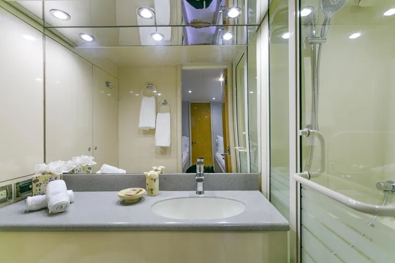 Slide: The Image of Luxurious bathroom in a 1994 Lazzara 76 yacht with modern fixtures and elegant design. - 21
