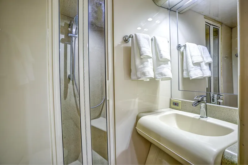 Slide: The Image of Luxurious bathroom in a 1994 Lazzara 76 yacht with shower and sink. - 24
