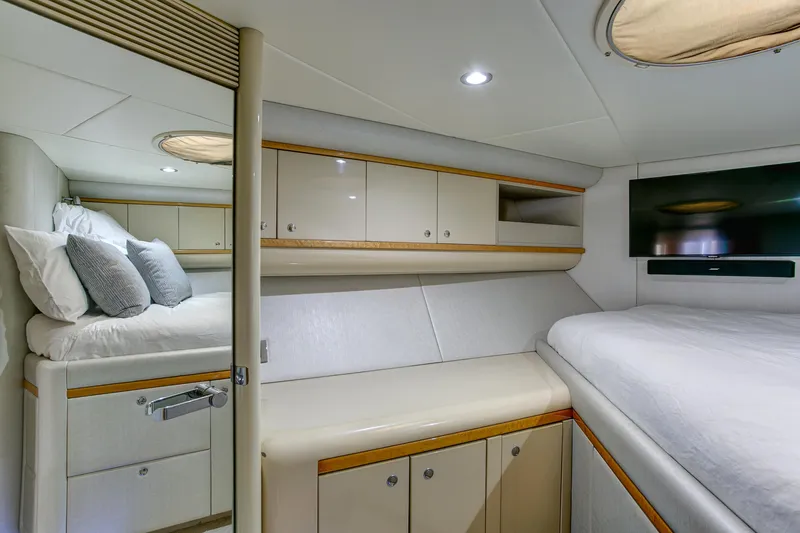 Slide: The Image of Luxurious 1994 Lazzara 76 yacht bedroom with modern decor and ample storage. - 26