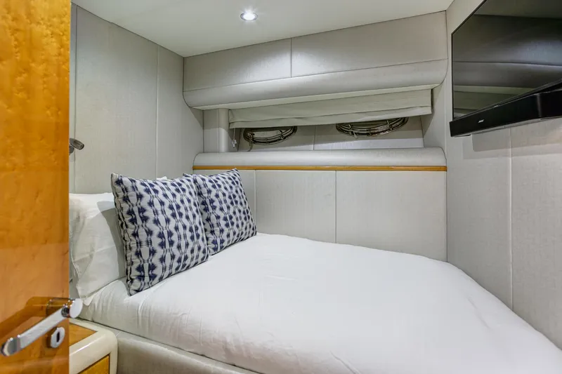Slide: The Image of Cozy bedroom in 1994 Lazzara 76 yacht with modern decor and TV. - 27