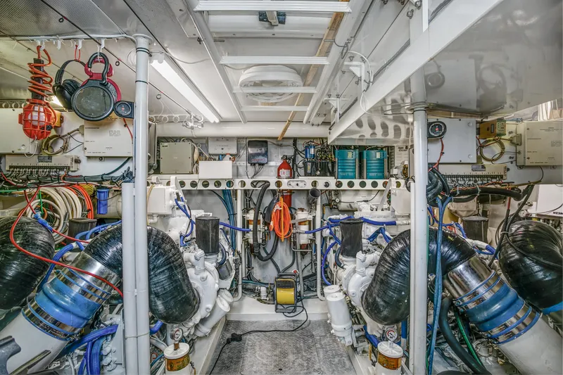 Slide: The Image of Engine room of a 1994 Lazzara 76 yacht, showcasing complex machinery and equipment. - 29