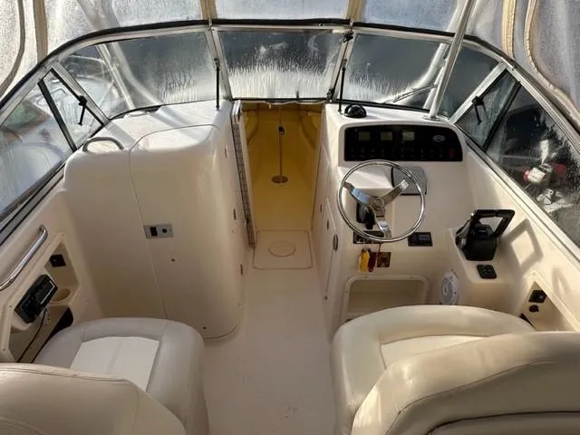 Slide: The Image of Interior of 2011 Grady-White Freedom 275 boat, featuring helm and seating area. - 6