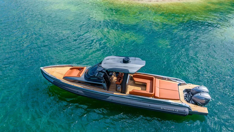 Slide: The Image of 2025 Capelli STRADIVARI 43 luxury boat on clear turquoise water. - 1