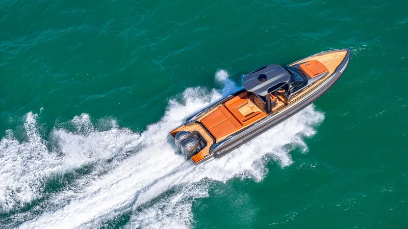 Slide: The Image of 2025 Capelli STRADIVARI 43 luxury boat cruising on turquoise water. - 16