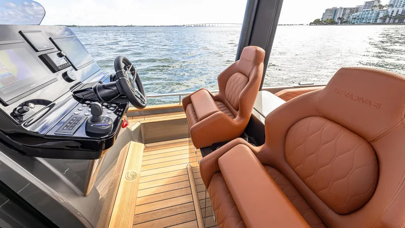 Slide: The Image of Luxurious interior of 2025 Capelli STRADIVARI 43 yacht with leather seating and modern controls. - 43
