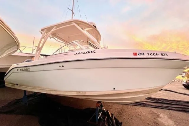 Slide: The Image of 2020 Century 24 Resorter boat with sleek white design, docked at sunset. - 1