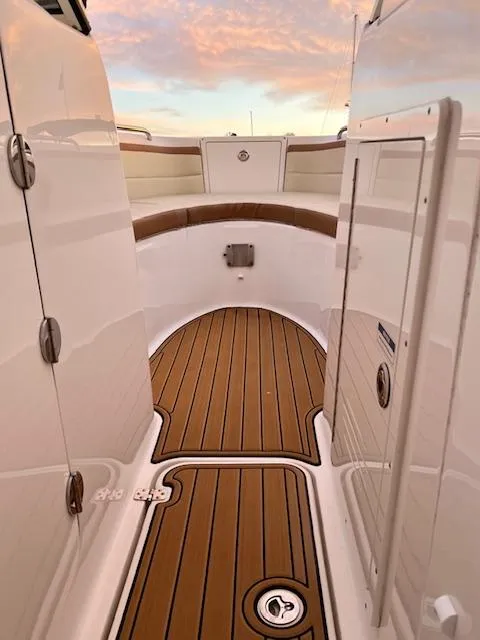 Slide: The Image of Century 24 Resorter 2020 boat interior with teak flooring and white panels. - 12