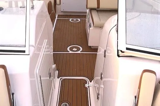 Slide: The Image of Century 24 Resorter 2020 boat interior with teak flooring and cushioned seating. - 16