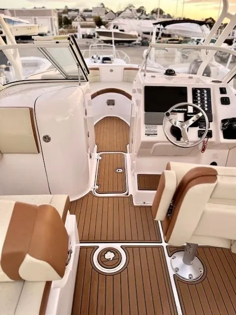 Slide: The Image of 2020 Century 24 Resorter boat interior with modern dashboard and seating. - 2