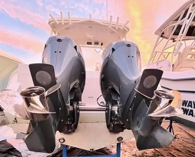 Slide: The Image of 2020 Century 24 Resorter boat with dual outboard motors at sunset. - 22