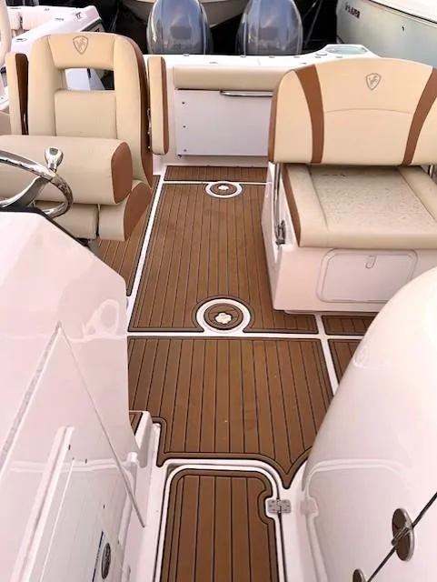 Slide: The Image of 2020 Century 24 Resorter boat interior with tan and white seating, teak flooring. - 3